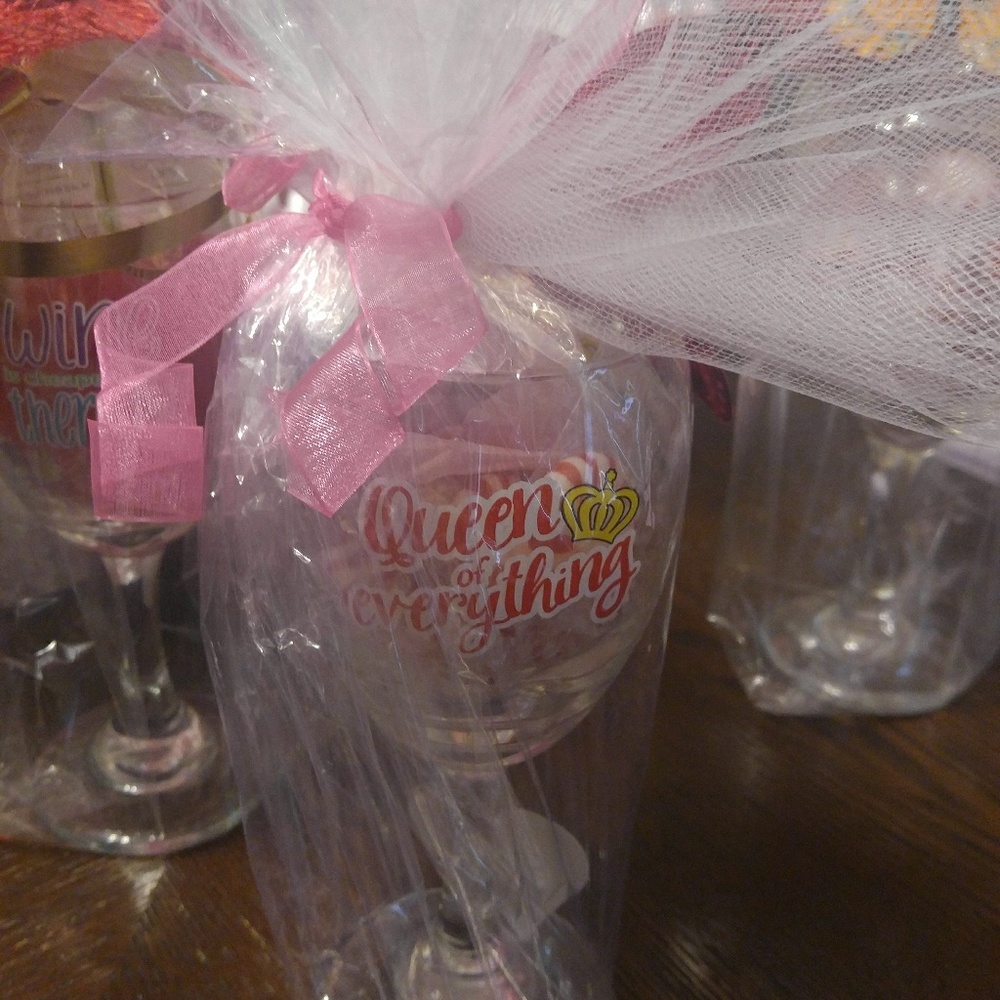 A gift cup with candies an a lip gloss.